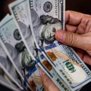 Mão segura notas de dólar